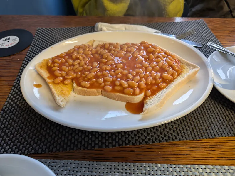 Beans on toast on a white plate