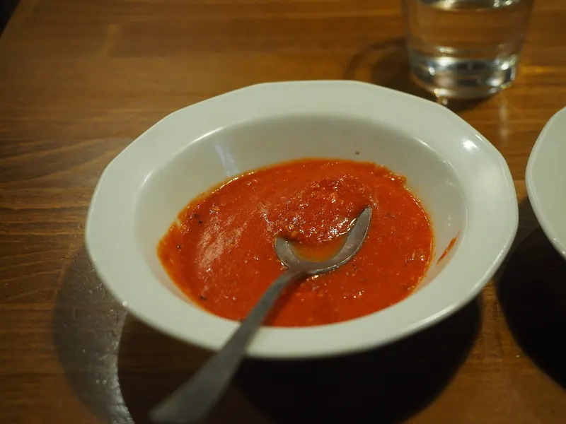 Bowl of tomato soup with a spoon