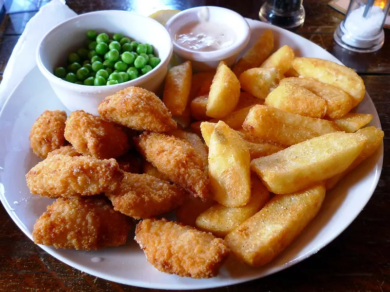 Scampi and chips with peas, served in a London pub